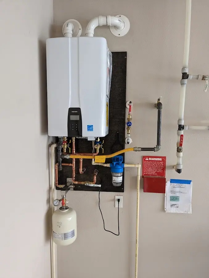 Professional plumber installing copper piping in a Roselle home